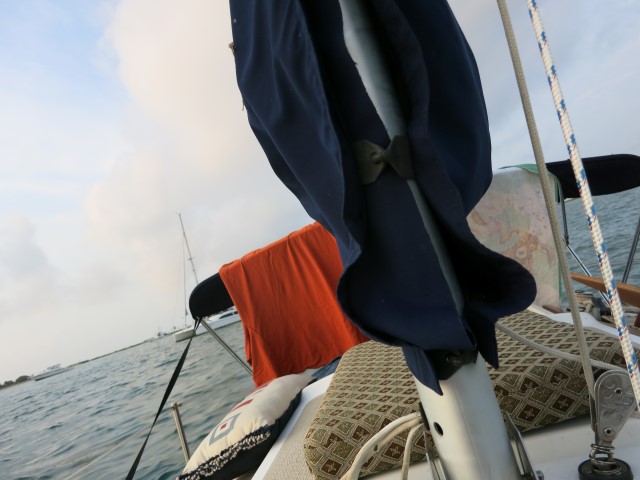 Cushions, towels, clothes drying out on deck.